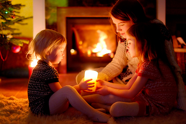 La luz de las velas y una chimenea encendida